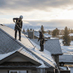 Professional roof snow removal and winter maintenance on a residential house.